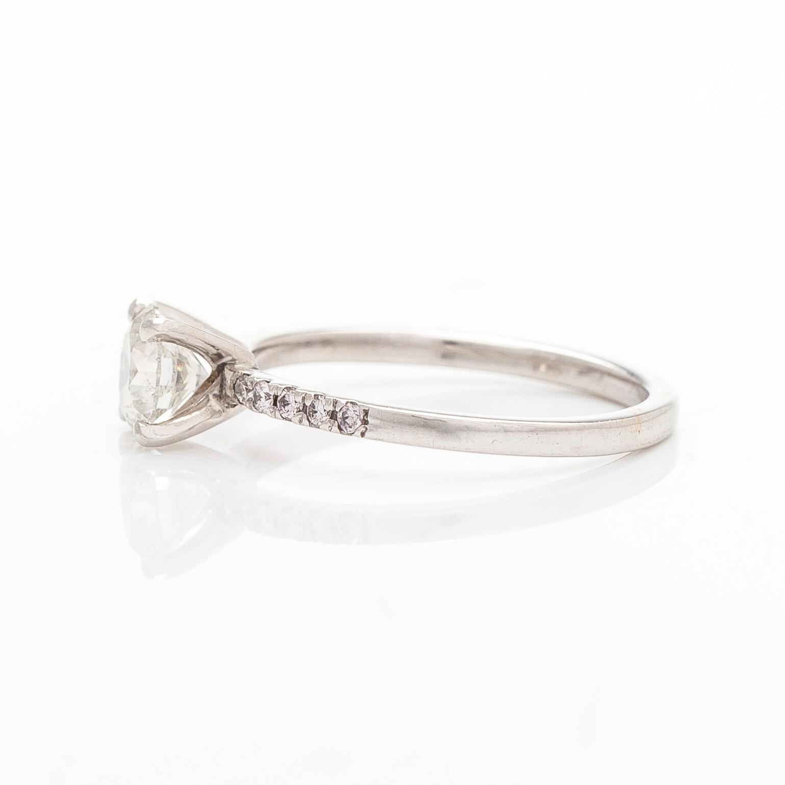 A 14K white gold ring with brilliant-cut diamonds.