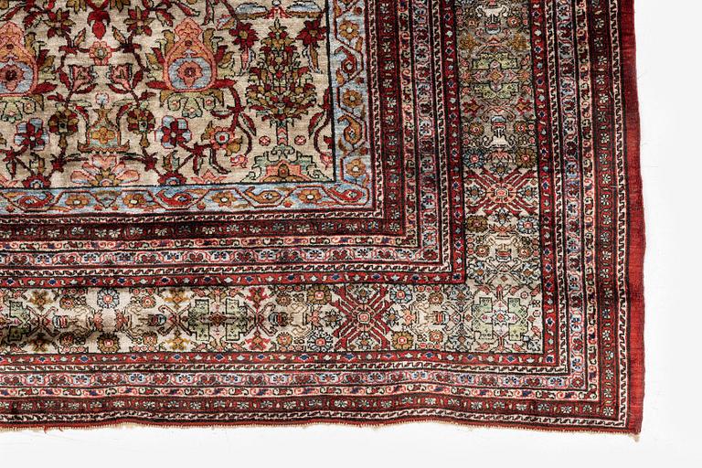 A semi-antique silk Qum rug, central Persia 221 x 138 cm.