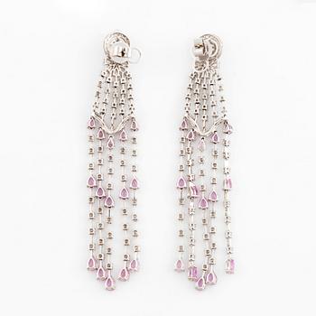 A pair of 18K white gold earrings set with faceted pink sapphires, drop- and round brilliant-cut diamonds.