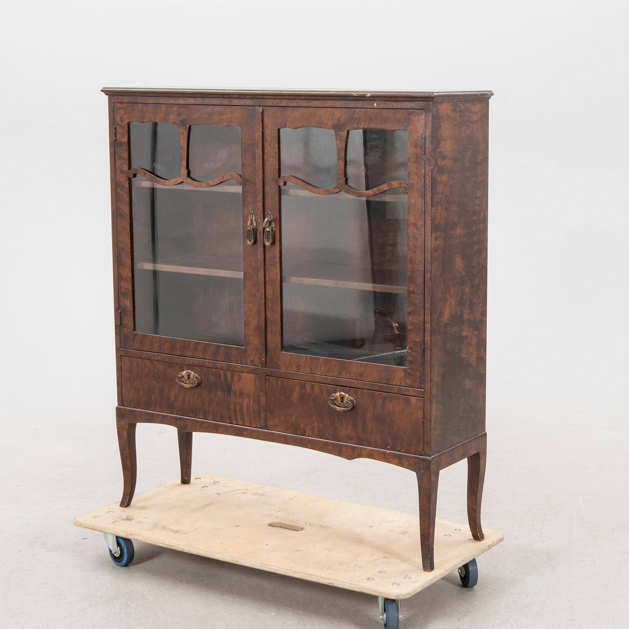 A 1920s  stained beech display cabinet.