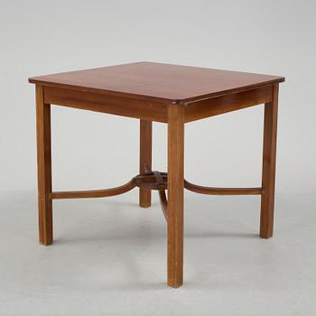 A mid 20th century mahogany veneered table from Nordiska Kompaniet (NK).