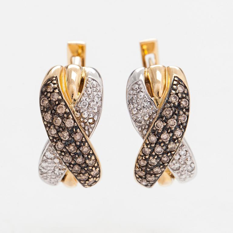 A pair of 14K white/yellow gold earrings, with clear and brown diamonds totaling approximately 0.40 ct.