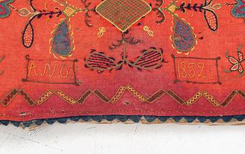 An embroidered carriage cushion, 100 x 50 cm, dated 1852.