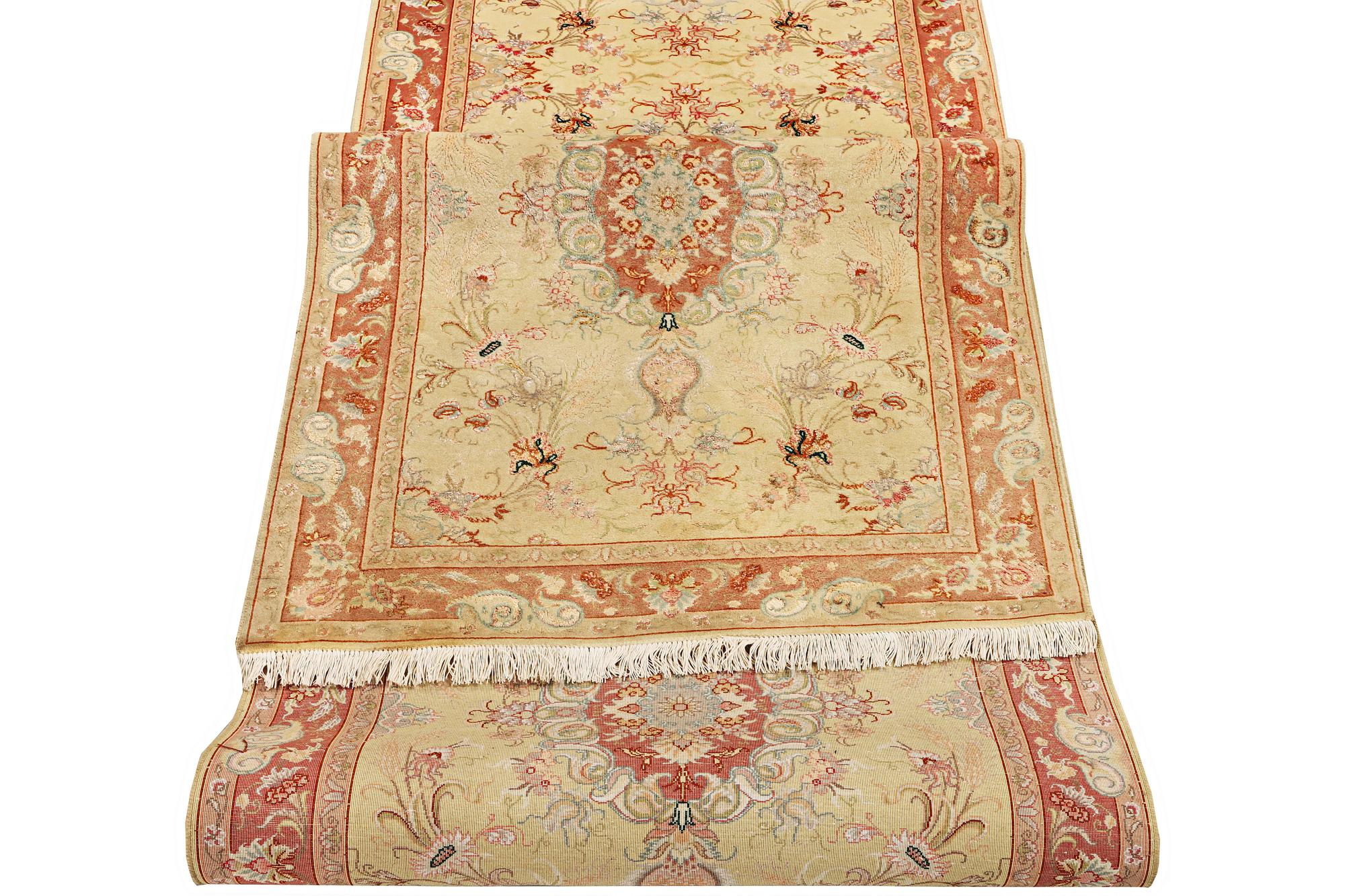 A Tabriz carpet, part silk, 50 raj, a. 508 x 85 cm.