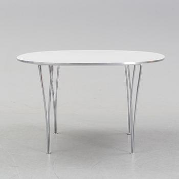 A 'Supercircular' table by Bruno Mathsson & Piet Hein for Fritz Hansen, dated 1985.