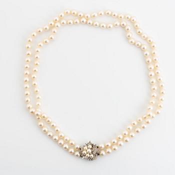 Cultured pearl necklace, clasp 14K white gold with pearl and eight cut diamonds.