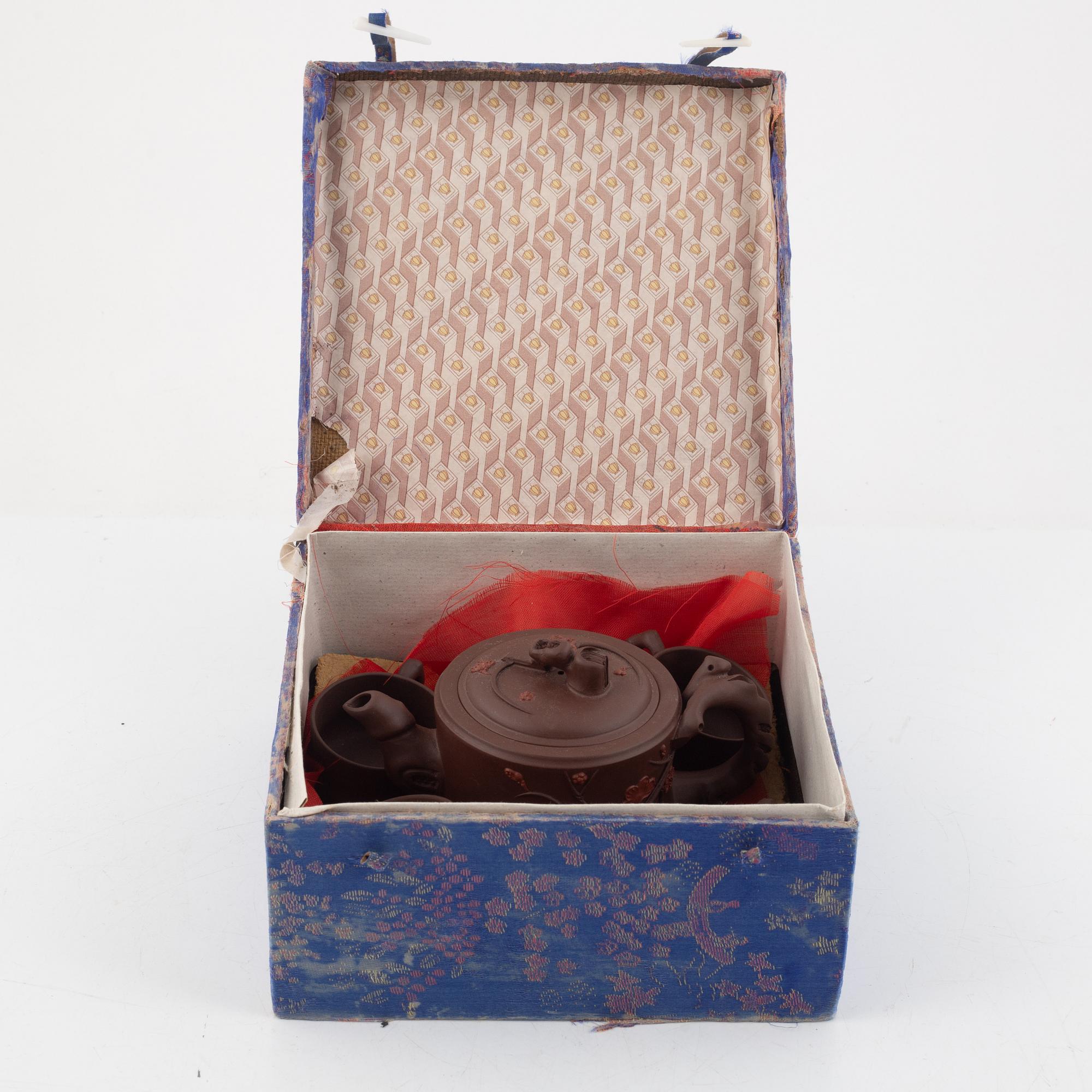 A Chinese yixing ware teapot with four cups, 20th century.