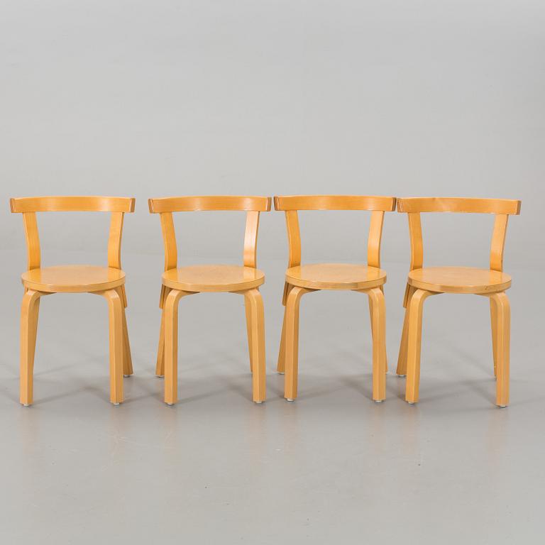A TABLE AND FOUR CHAIRS DESIGNED BY ALVAR AALTO FOR ARTEK.