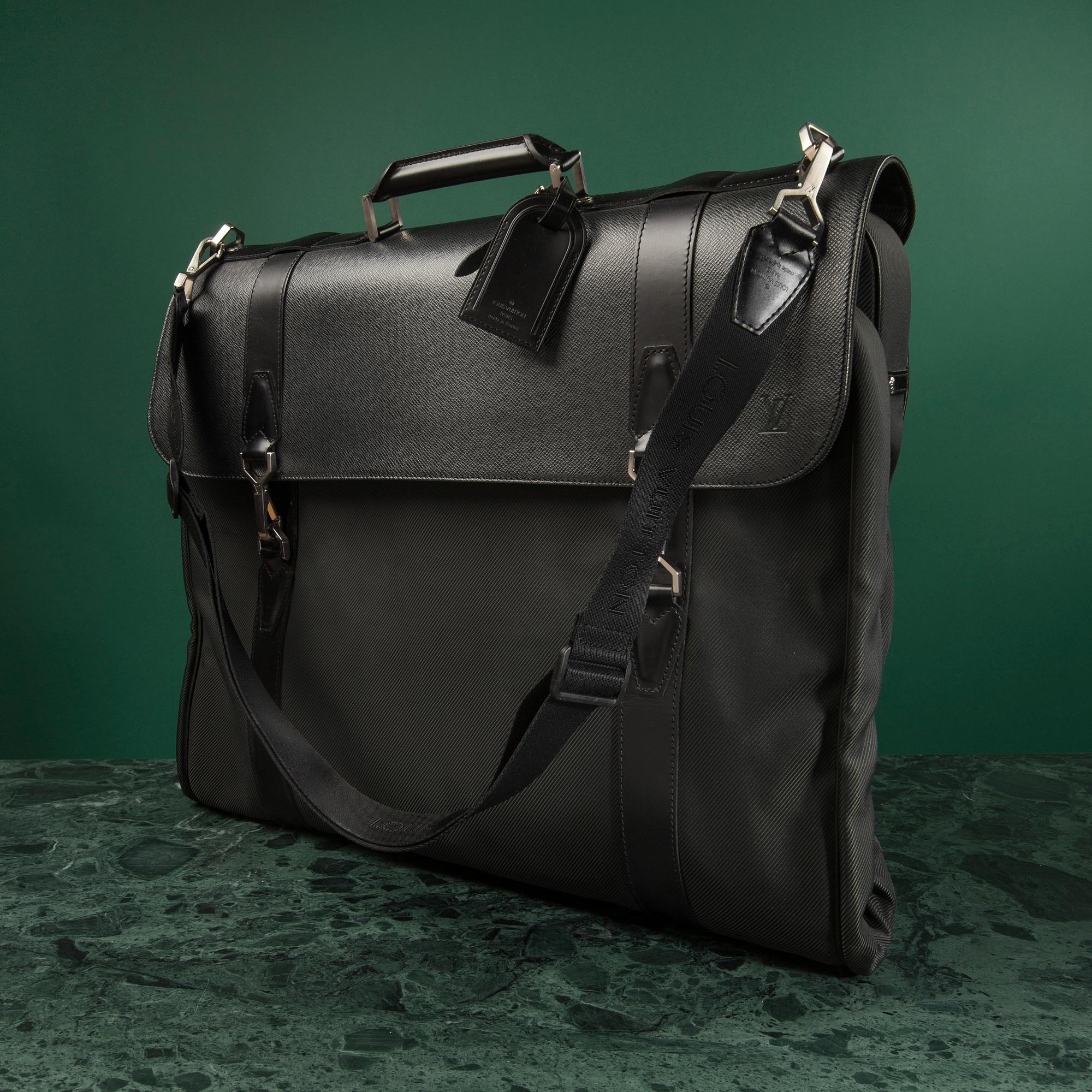 A Garment bag by Louis Vuitton.