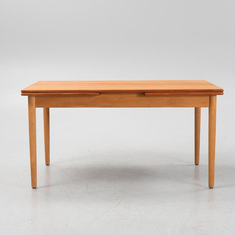 Hans J. Wegner, an oak and teak dinner table for Andreas Tuck. Denmark.