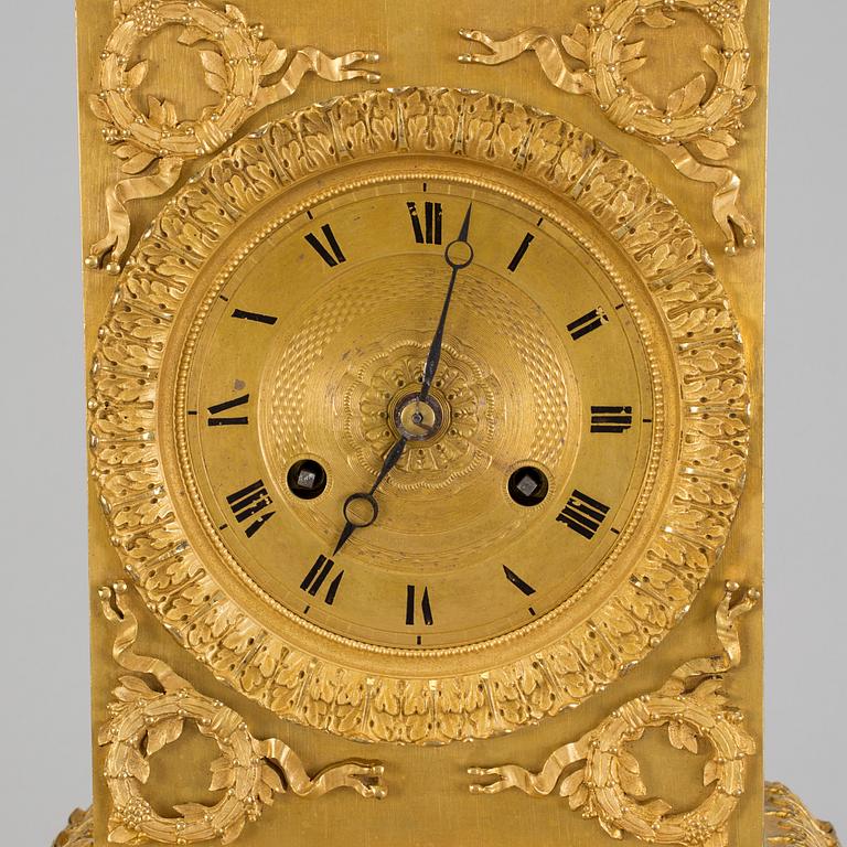 A French gilt bronze Empire mantle clock, early 19th Century.