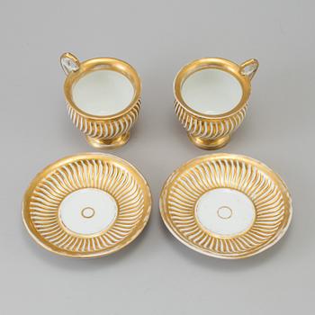 a pair of late empire porcelain cups with saucers from the first half of the 19th century.