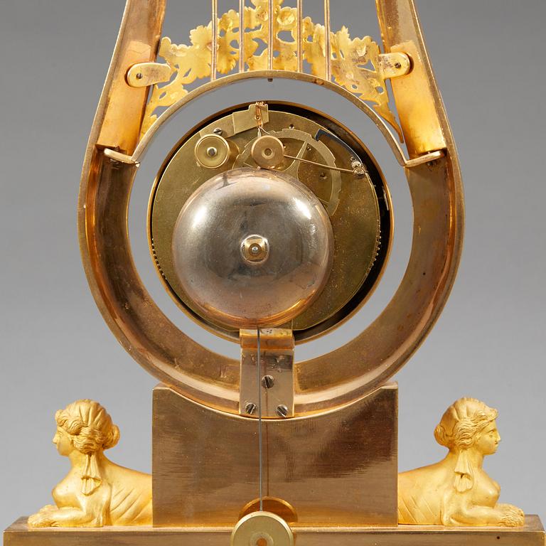 A late Gustavian early 19th century gilt bronze mantel clock.