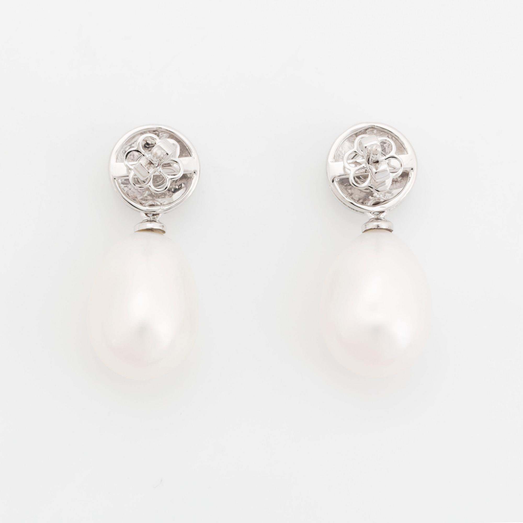A pair of 18K white gold and cultured pearls earrings set with round brilliant-cut diamonds.