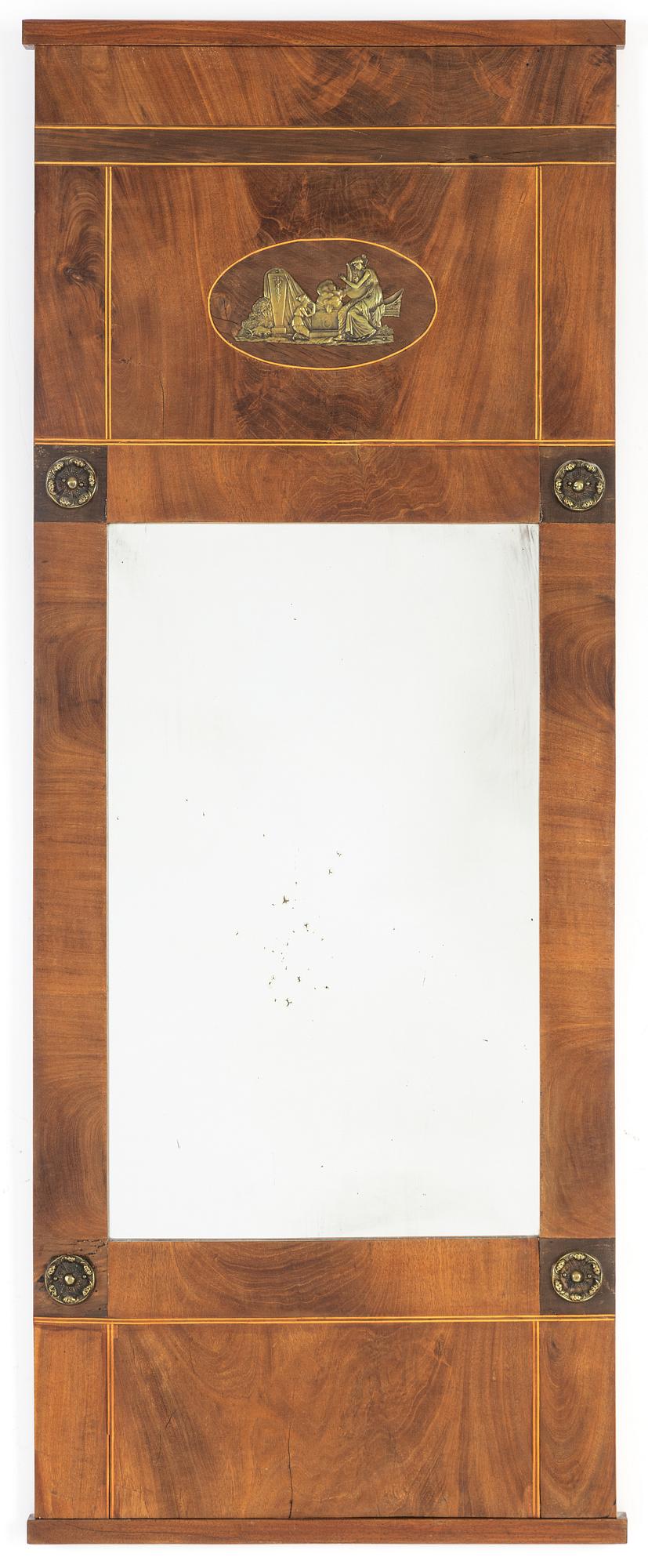A mahogany veneered Empire mirror, first half of the 19th Century.