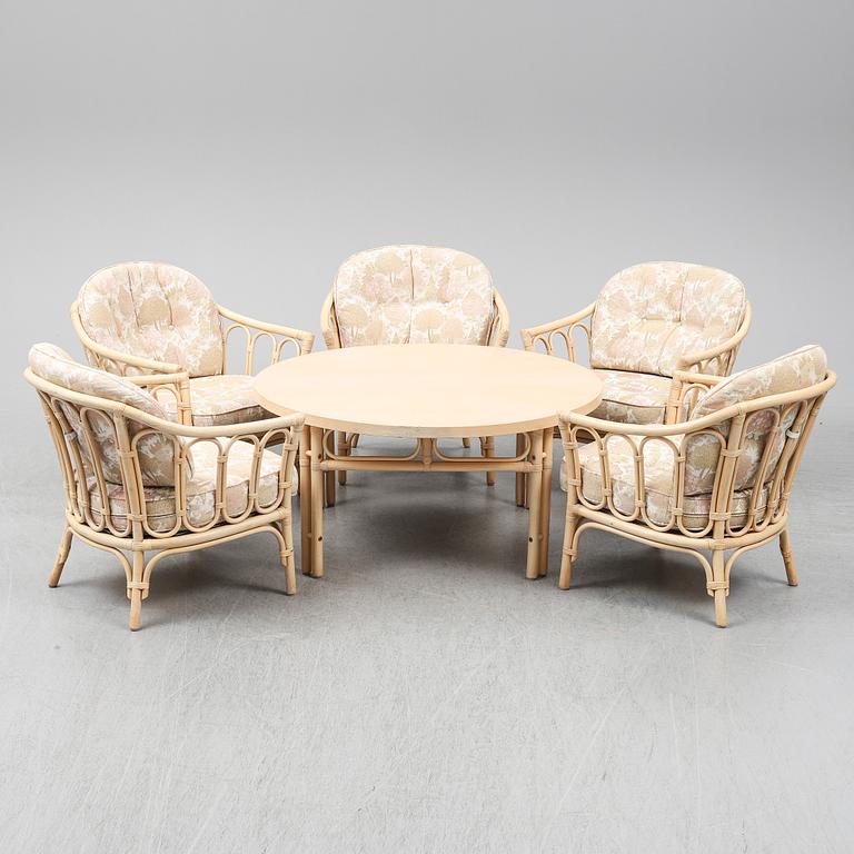 Five rattan easy chairs and a table. 1980's.