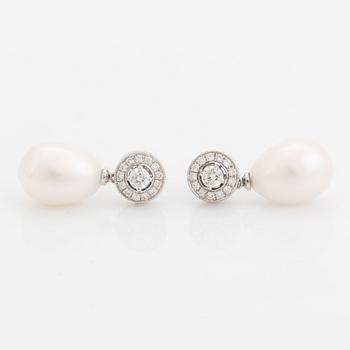 A pair of 18K white gold and cultured pearls earrings set with round brilliant-cut diamonds.