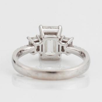 A RING set with an emerald-cut diamond.