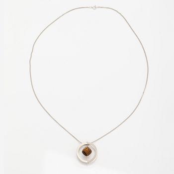 Elis Kauppi, A silver necklace/brooch with a tiger's eye. Kupittaan kulta, turku 1961.
