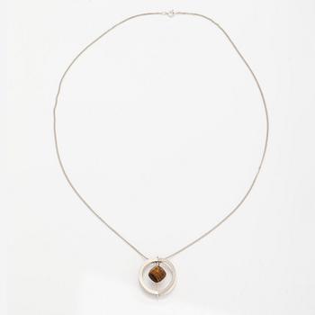 Elis Kauppi, A silver necklace/brooch with a tiger's eye. Kupittaan kulta, turku 1961.