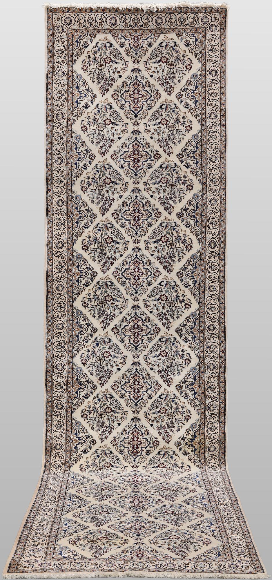 A Nain part silk carpet, 408 x 98 cm.