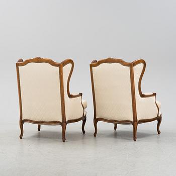 A pair of Rococo style armchairs, first half of the 20th Century.