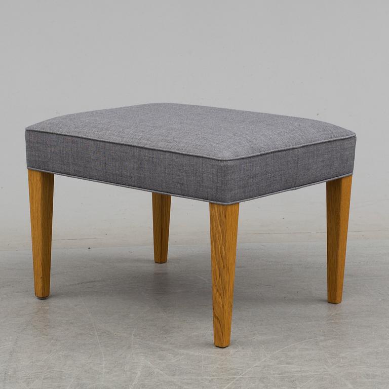 An easy chair and foot stool by Frits Hansen for Carl Hansen & Son.