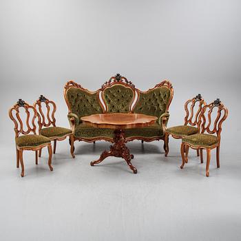 A rococo style sofa, four chairs and a table, second half of the 19th Century.