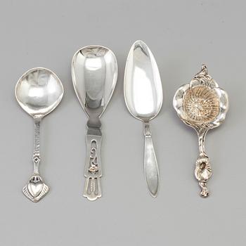 Three Art Nouveau silver serving spoons, one with maker's mark Emil O. Möller, Malmö, Sweden 1935 and a tea strainer, US.