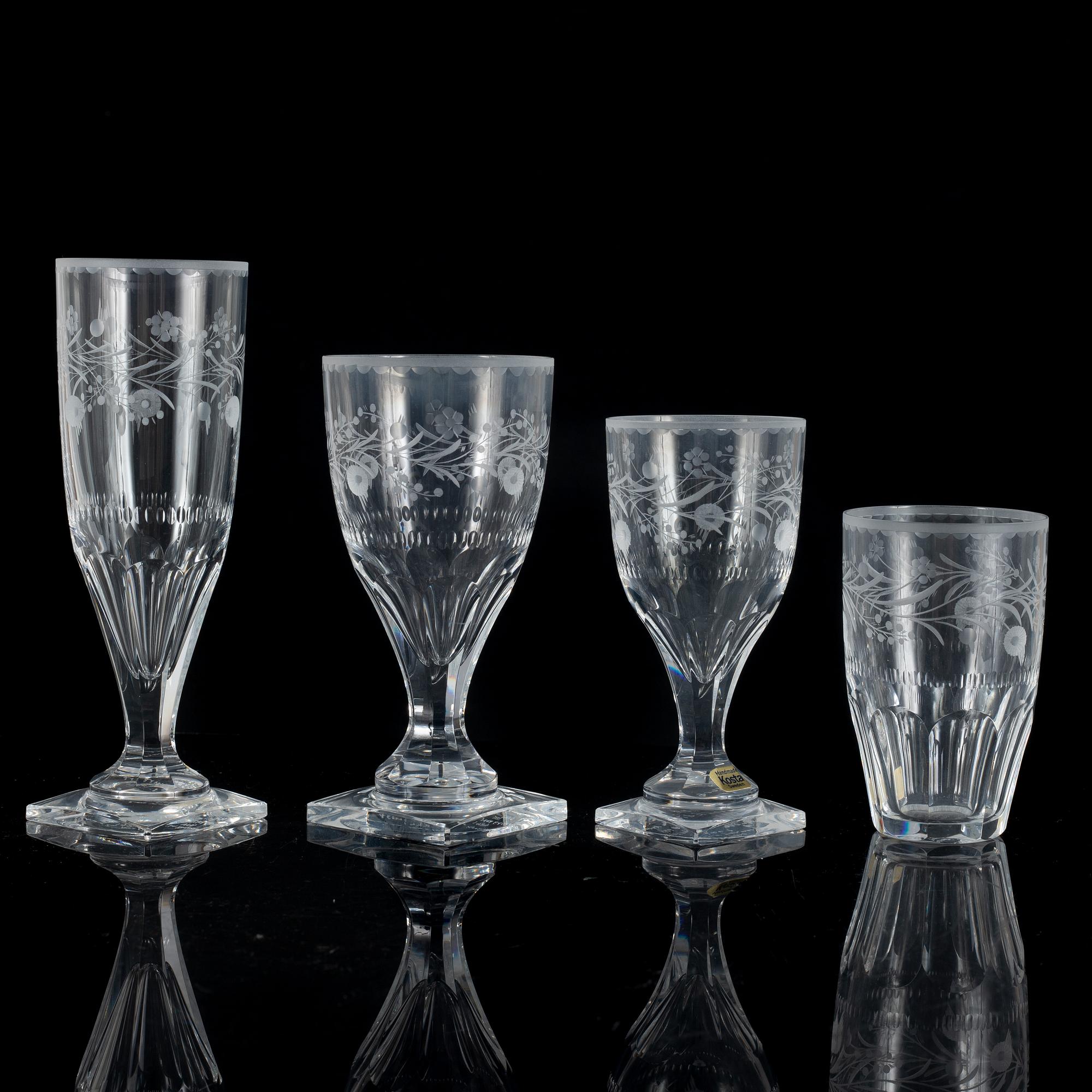 A display cabinet with a 47-piece glass service, "Koskull" from Kosta, Sweden.