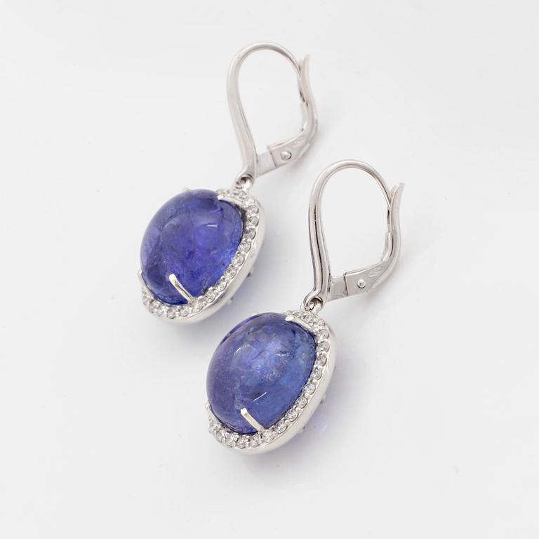 Cabochon-cut tanzanites and diamond earrings.