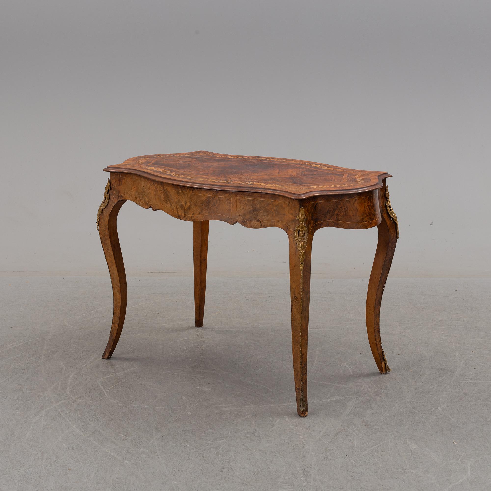a rococo-style table/desk from England in the late 19th century.