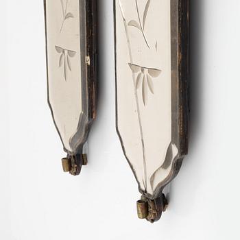 A pair of rococo-style girandole mirrors, early 20th century incorporating older elements.