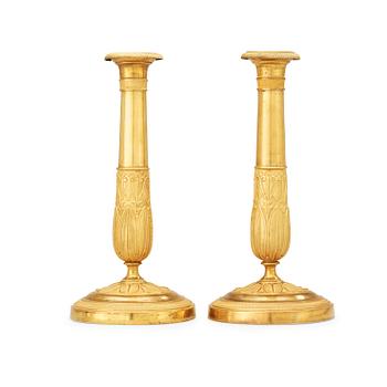 516. A pair of French Empire early 19th century candlesticks.