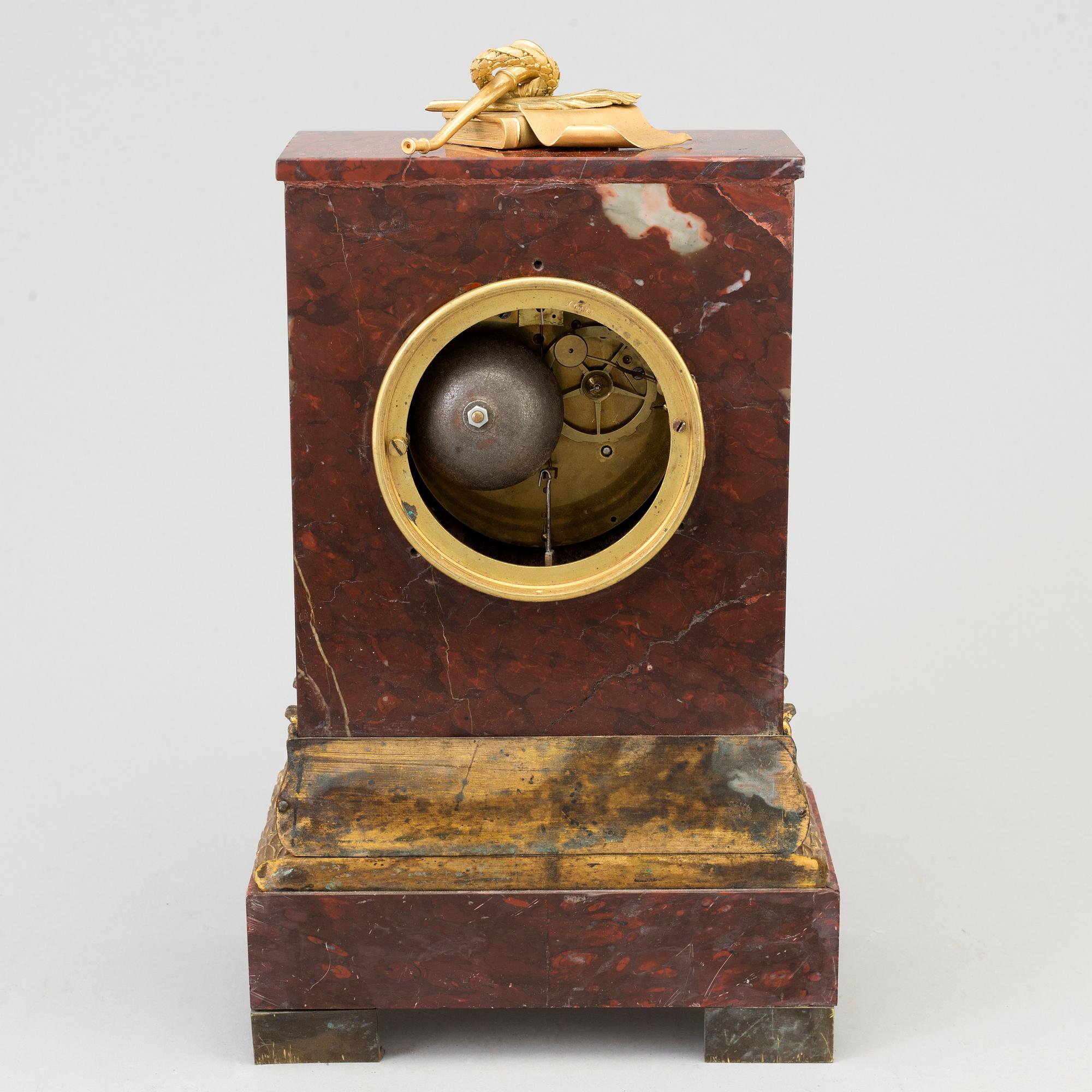 AN EMPIRE ORMOLU AND MARBLE MANTEL CLOCK, first half of the 19th century.