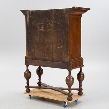 A stained pine Baroque cabinet, on a later stand. From around the year 1700.