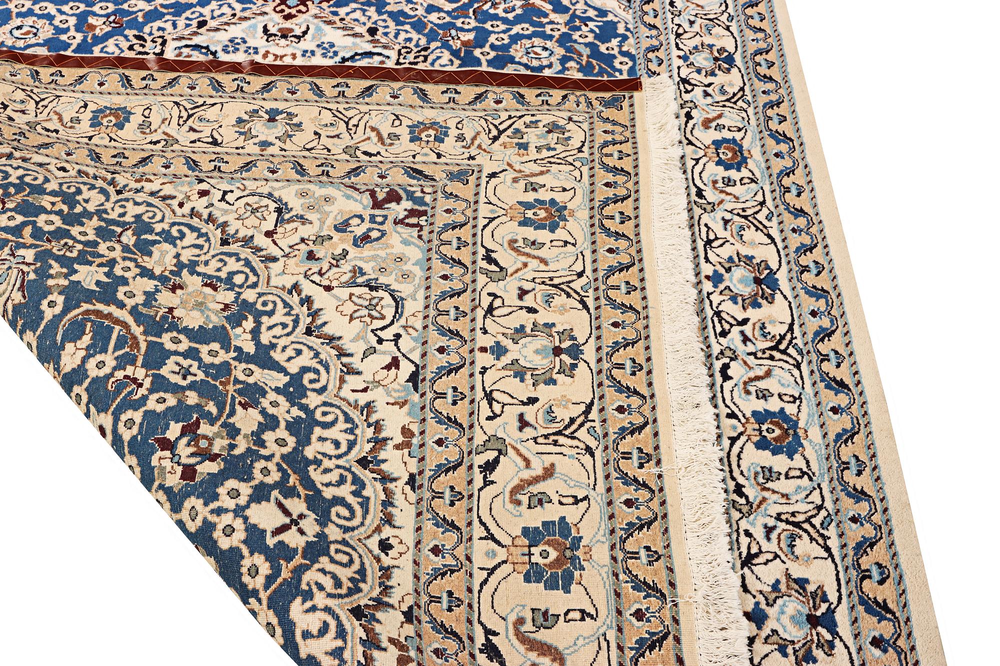 A Nain carpet, part silk, 9 laa, c. 300 x 189 cm.