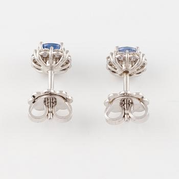 A pair of 14K gold earrings with faceted sapphires and eight-cut diamonds.