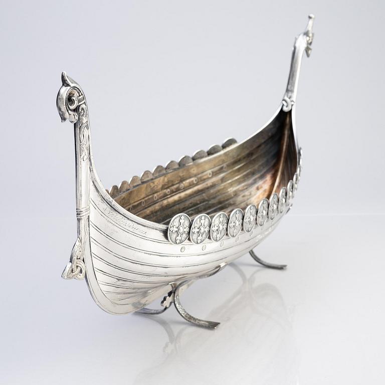 A Norwegian early 20th century silver longboat, mark of David Andersen and two small ones with Swedish marks.