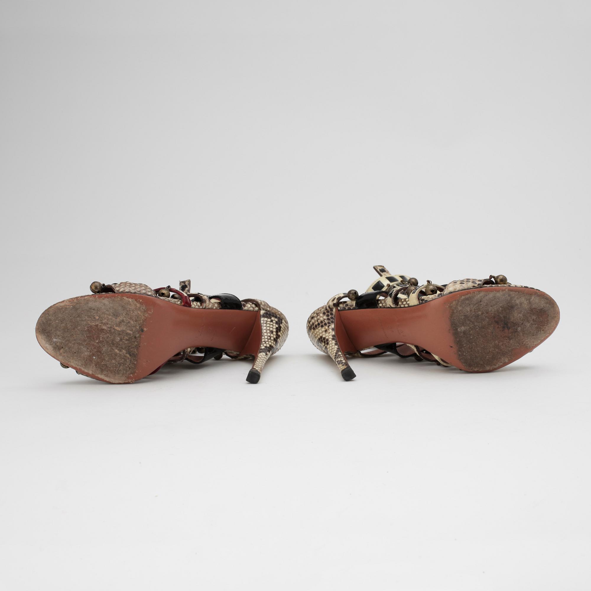 AZZEDINE ALAÏA, a pair of sandalettes with patent leather straps.