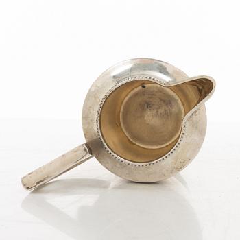 A silver coffee pot, creamer and sugar bowl, import marks of Axel Larson, Helsingborg 1920.