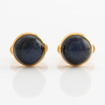 CF Carlman a pair of 18K gold earrings with a blue stone, likely spectrolite.