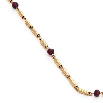 A 16K gold necklace with garnets.