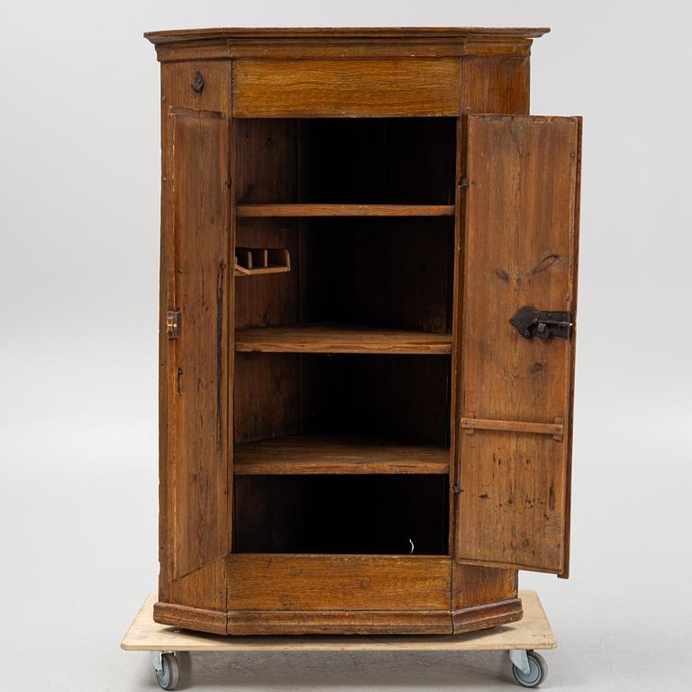 An early 19th Century provincial corner cabinet.