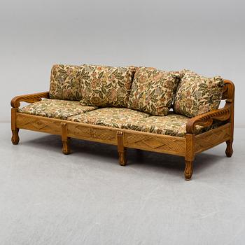 KNUT FJAESTAD, a folk art stained wood sofa/bed,  Sweden, early 20th C.