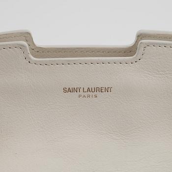 Yves Saint Laurent, a white leather handbag.