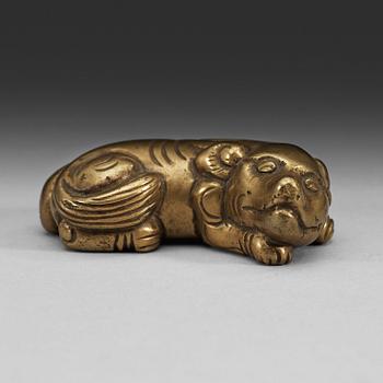 100. A bronze paper-weight modeled as a reclining lion, Qing dynasty, presumably 18th Century.