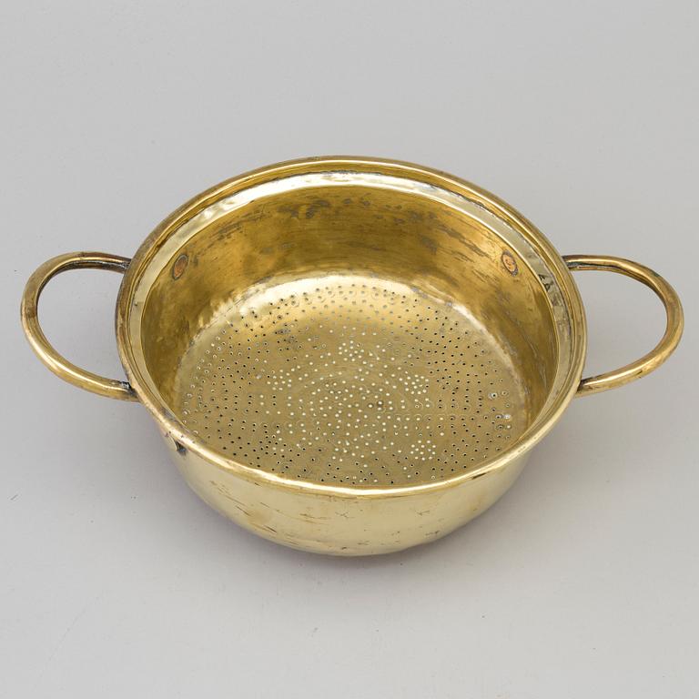An 18th century brass colander.