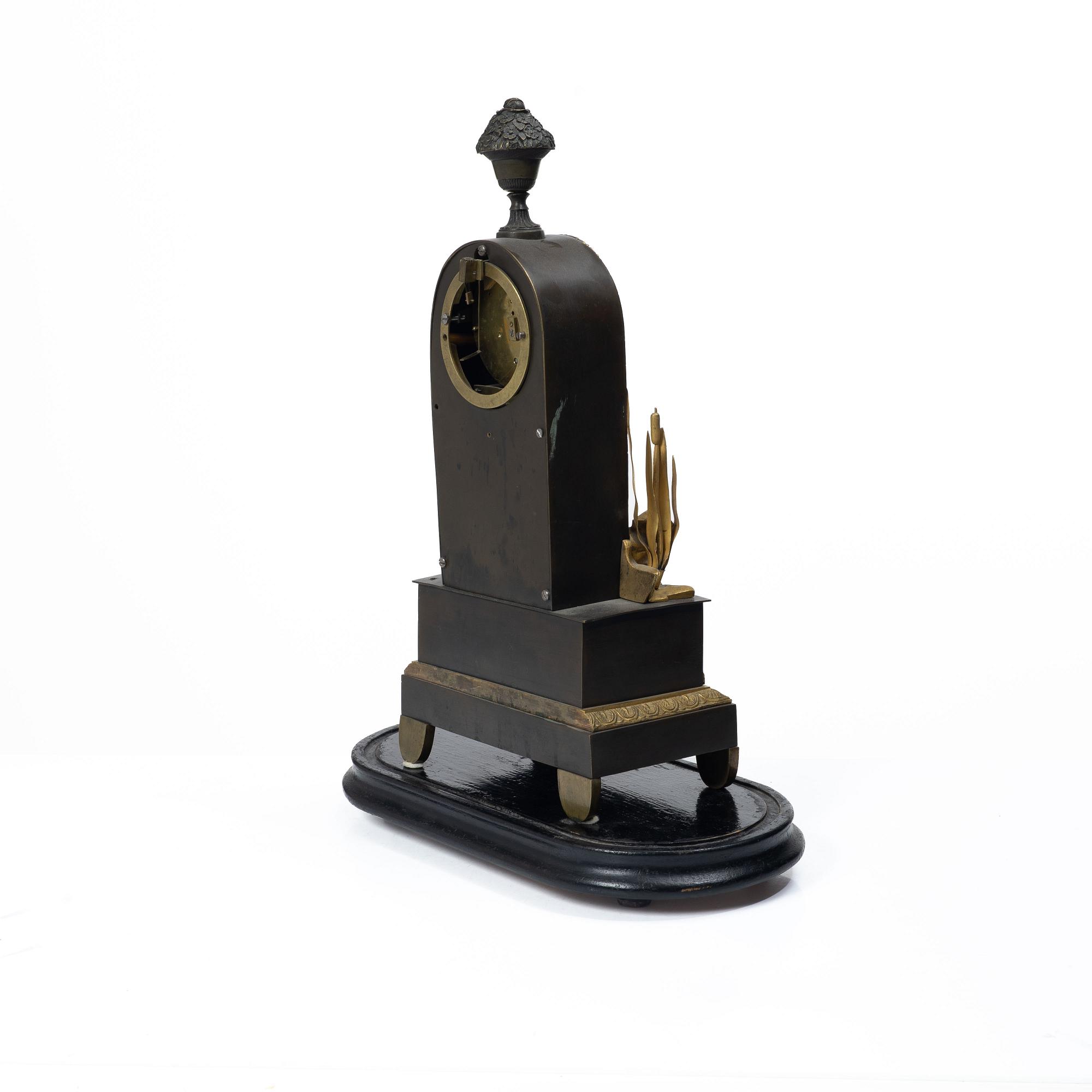 A French Charles X ormolu and patinated bronze mantel clock, ca 1820's.