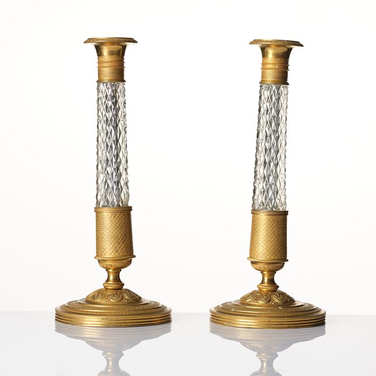A pair of French gilt bronze and cut-glass Empire-style candlesticks, later part of the 19th century.